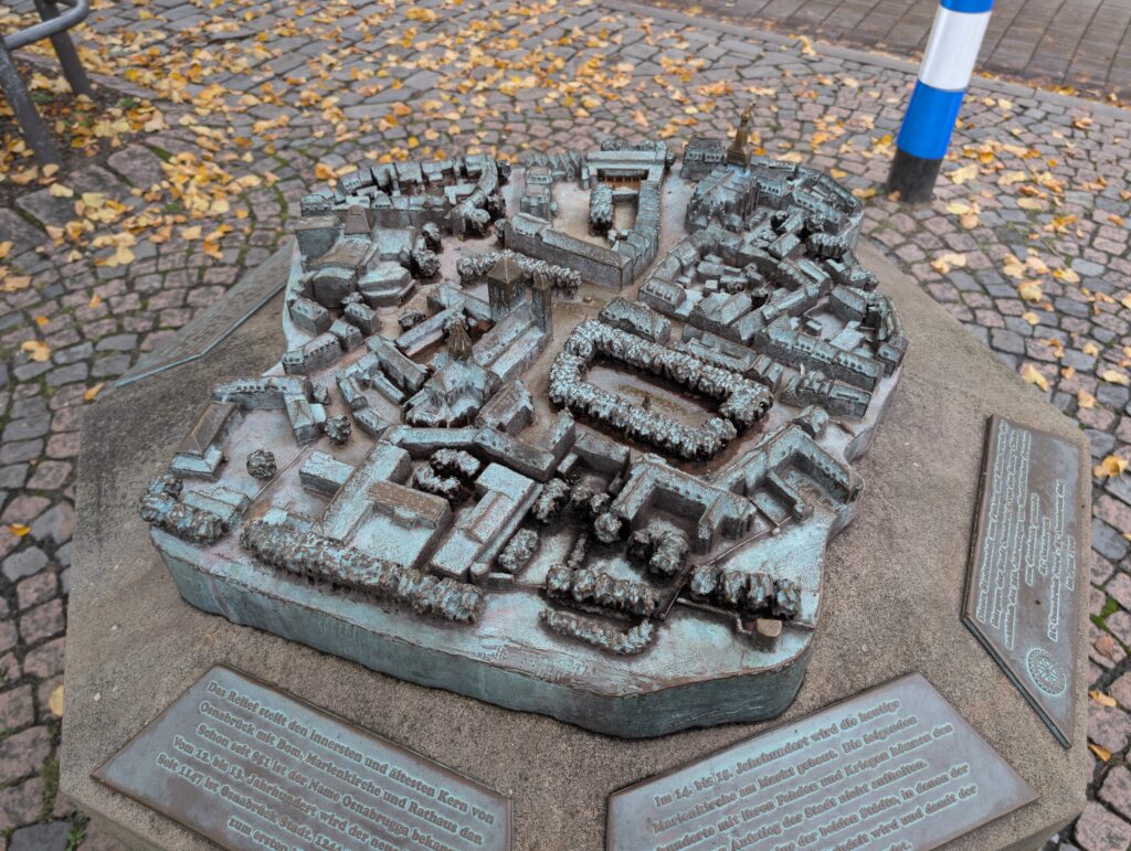 Picture of an old statue depicting a model of the streets of Osnabrück