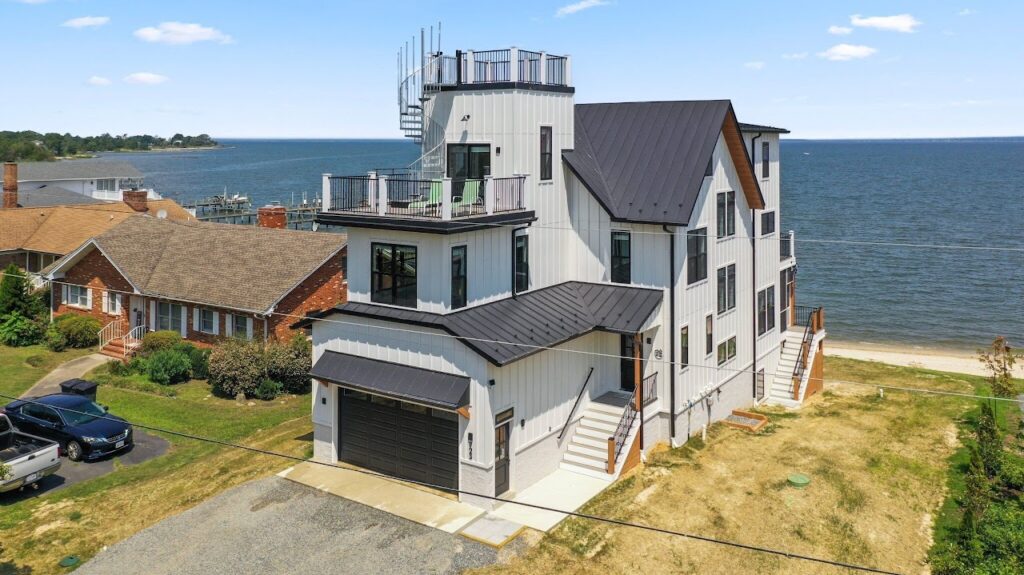 Ariel shot of the Vrbo rental we stayed at. It is a 3-4 story tall building with a crows nest out looking a beach.